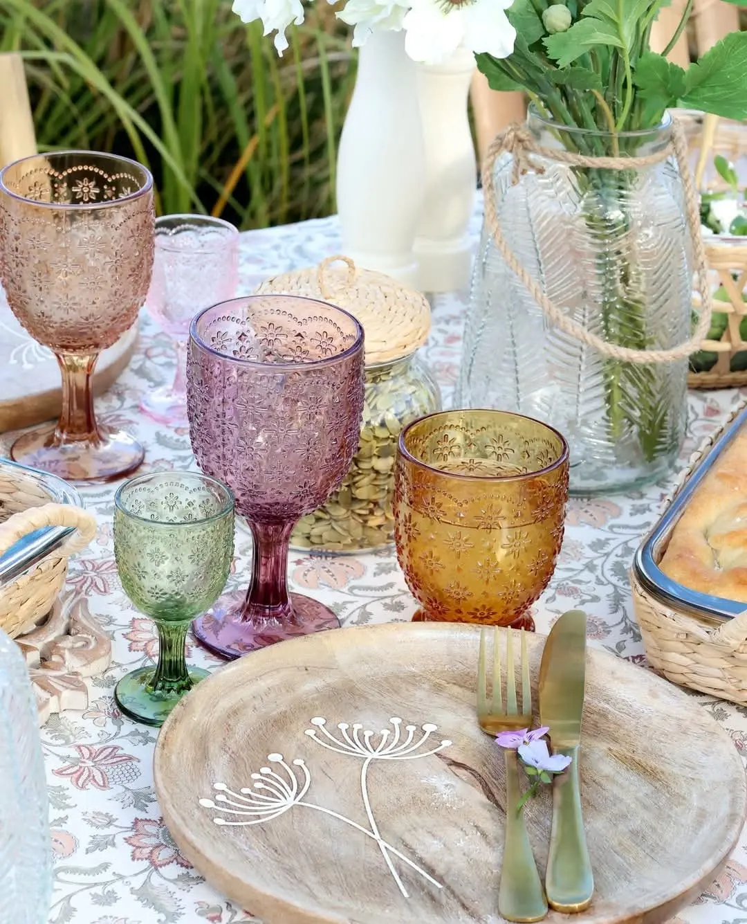 Table set with colourful glasses, ceramics and flowers at Break